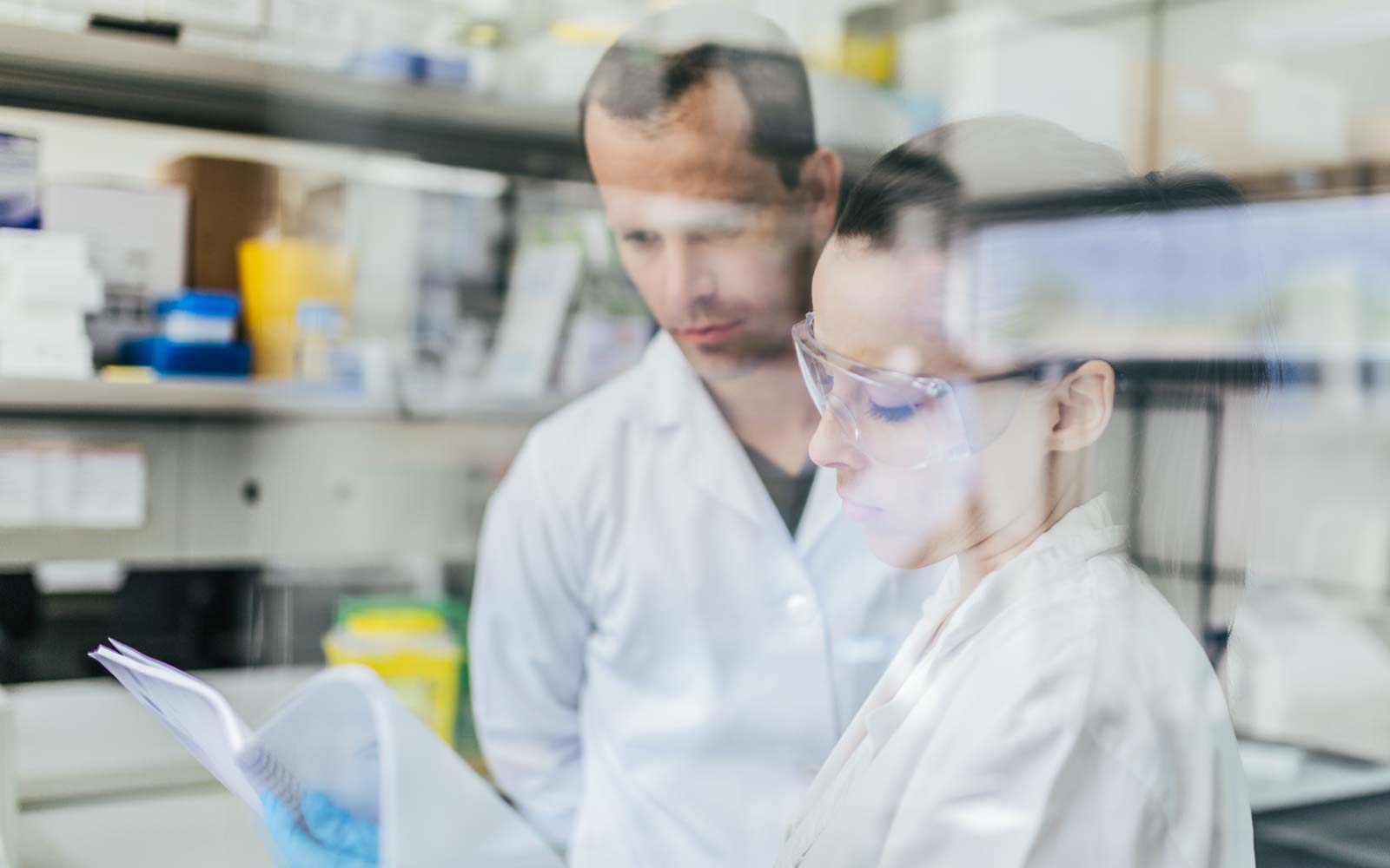 Two technicians looking at a report in a lab